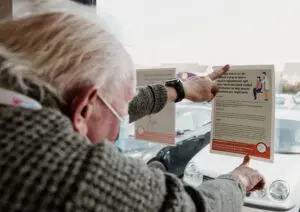 Volunteer Champion John putting up posters in his local area