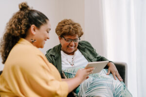 Two people using a digital tablet