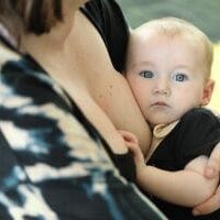 Baby cuddled up to mother's chest