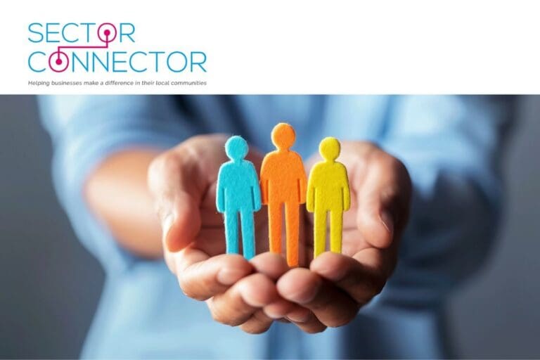 hands holding 3 brightly coloured people cut outs to indicate wellbeing
