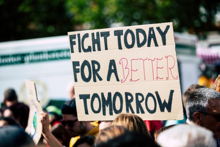 Sign held up at protest that reads - Fight today for a better tomorrow