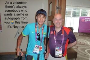 Man in purple shirt having a selfie with Nemar (footballer), in turquoise shirt.