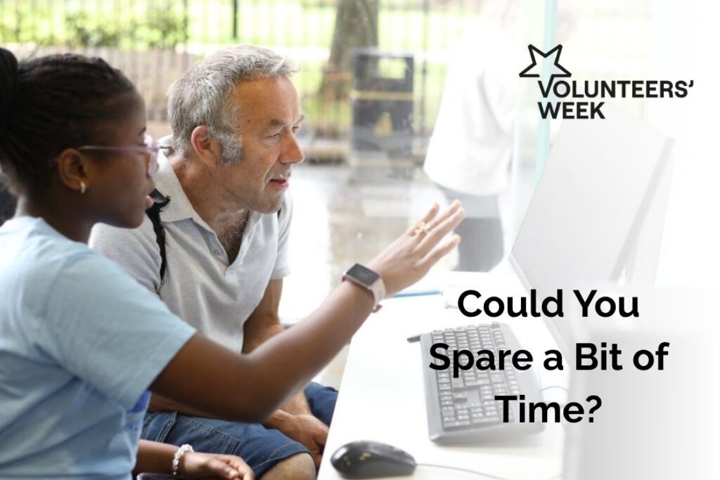 Volunteers Week Could You Spare a Bit of Time - shows a young woman showing an older man how to use a computer